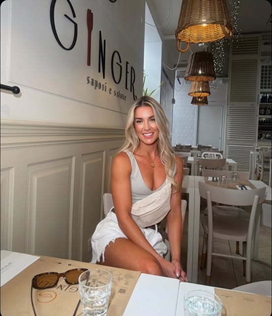 Kelly smiling at a restaurant table